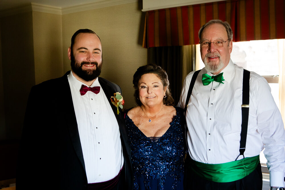 Groom with his parents before wedding ceremony