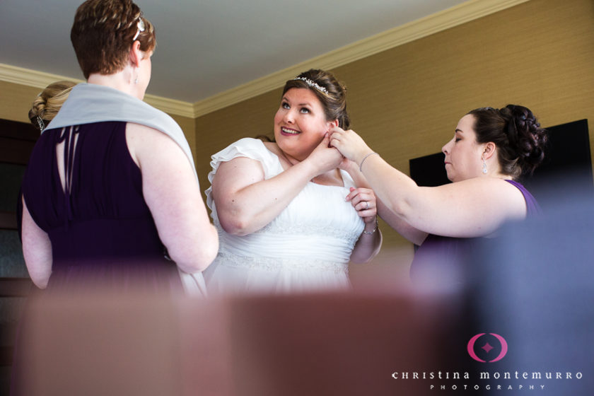 Happy bride puts on her jewelry 