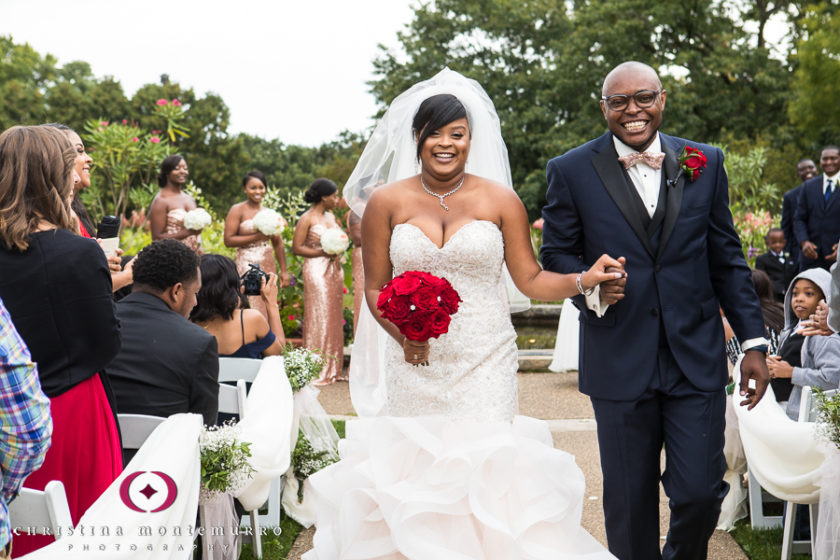 Smiling Bride and Groom walking out of their ceremony at Phipps