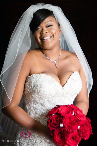 Beautiful bride with strapless dress and red rose bouquet with bling