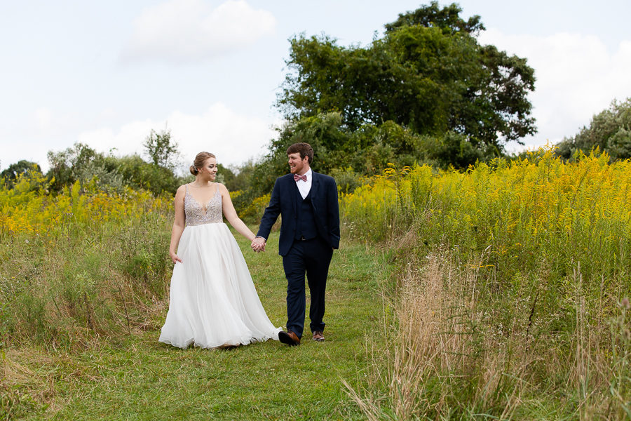 Bride and Groom in a field of yellow wildflowers