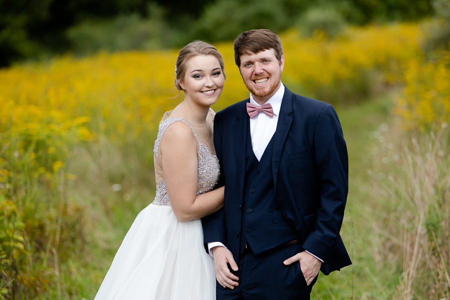 Bride and Groom in a field of yellow wildflowers